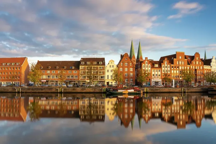 Framed Print : Houses on riverfront of Trave river with towers of St. Marienkirche church in background at sunset, Lubeck, UNESCO, Schleswig-Holstein, Germany Framed Print : Houses on riverfront of Trave river with towers of St. Marienkirche church in background at sunset, Lubeck, UNESCO, Schleswig-Holstein, Germany
