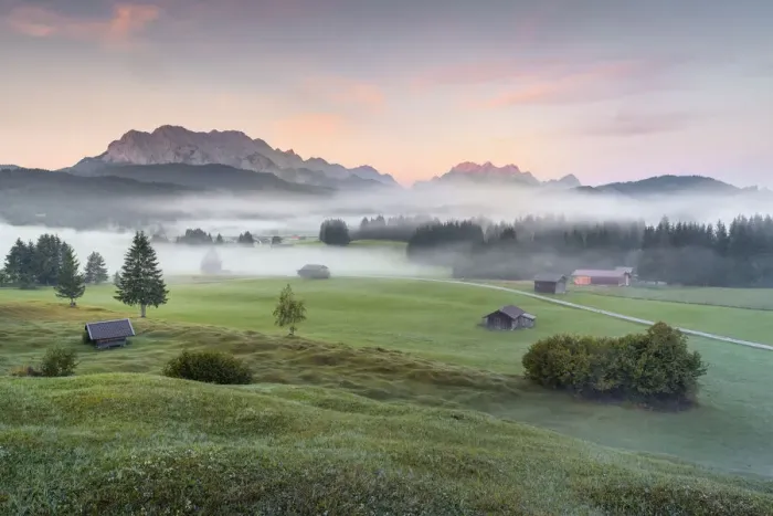 Framed Print : humped meadows with wafts of mist at sunrise and Karwendel Range and Zugspitz-Massif