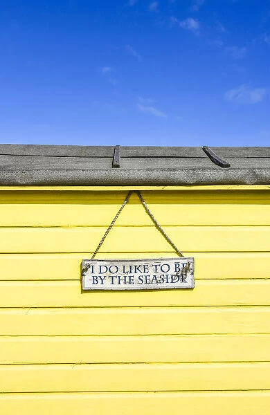 'I do like to be beside the seaside' traditional beach hut on Littlestone beach, Kent, England
