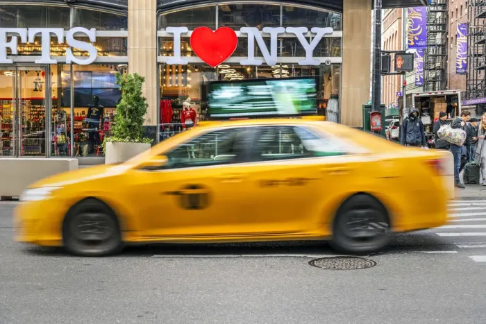 Framed Print : I Love New York gift shop sign and blurred yellow taxi cab passing, Times Square Framed Print : I Love New York gift shop sign and blurred yellow taxi cab passing, Times Square