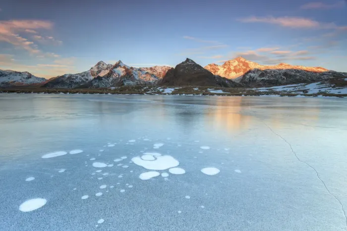 Framed Print : Ice bubbles on the frozen surface of Andossi Lake at sunrise Spluga Valley Valtellina