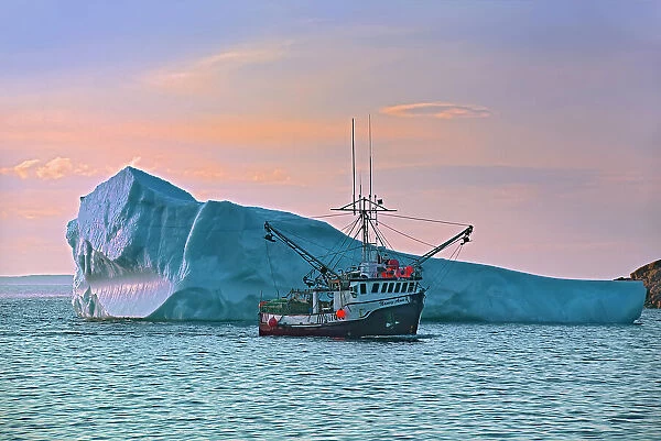 Iceberg and fishing boat returning from the Atlantic Ocean. Baie Verte Peninsula. La Scie, Newfoundland & Labrador, Canada