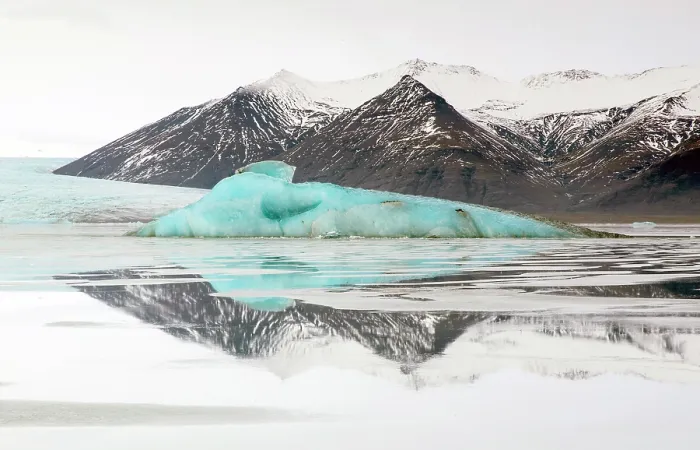 Framed Print : Iceberg and snow covered mountains reflecting in glacial water, Jokulsarlon Glacier Lagoon, South Iceland