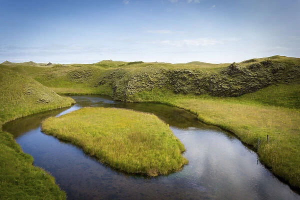 Iceland, green landscape and river meander with grass island
