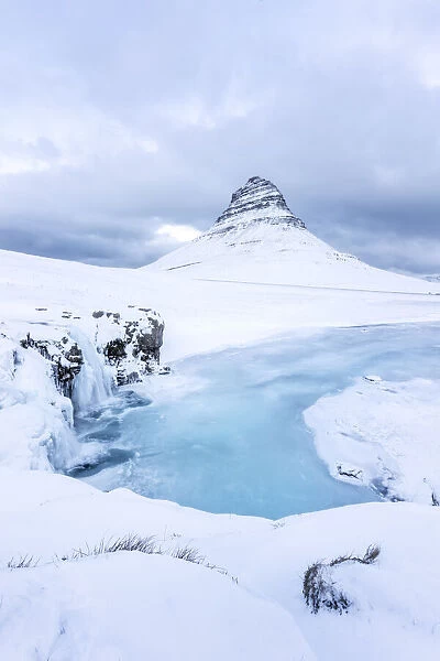 Iceland: Snaefellsnes peninsula: frozen waterfall under the Kirkjufell