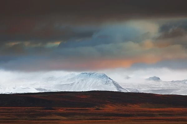 Iceland, West Iceland, Vesturland, Lava fields and snow covered mountains in the