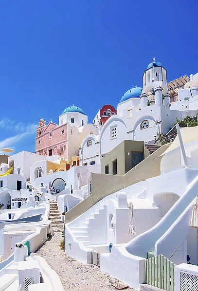 Iconic blue domed churches of Saint Spyridon and Resurrection of the Lord, low angle view, Oia Village, Santorini or Thira Island, Cyclades, Greece