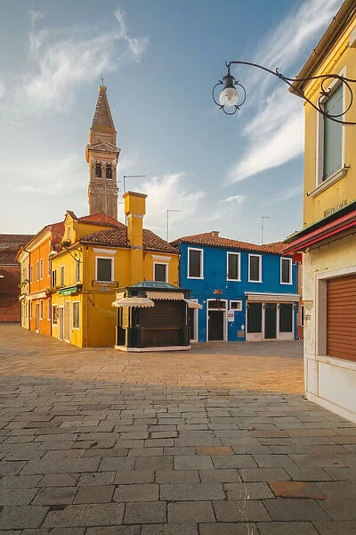 The iconic leaning bell-tower of Burano at dawn, Venice, Veneto, Italy