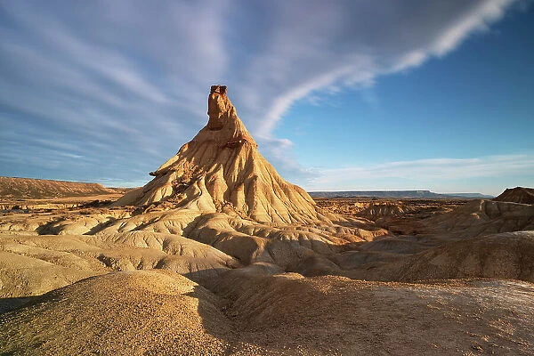 the iconic rock formation called Castel de Tierra during a warm summer sunrise, Bardenas Reales Natural Park, Navarra, Spain