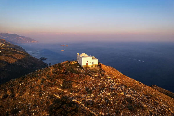 Iconic white church of San Costanzo on top of the mountain surrounding Amalfi coast, Punta Campanella, Ieranto bay, Nerano, Amalfi coast, Naples province, Campania, Italy