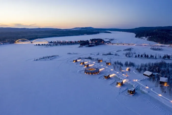 Framed Print : Illuminated floating circular building and wood cabins of Arctic Bath Hotel in the snow at dusk, Harads, Lapland, Sweden