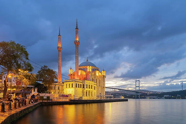Illuminated Grand Mecidiye Mosque (Ortakoy Mosque) with Bosphorus Bridge in background at twilight, Ortakoy, Besiktas District, Istanbul Province, Turkey