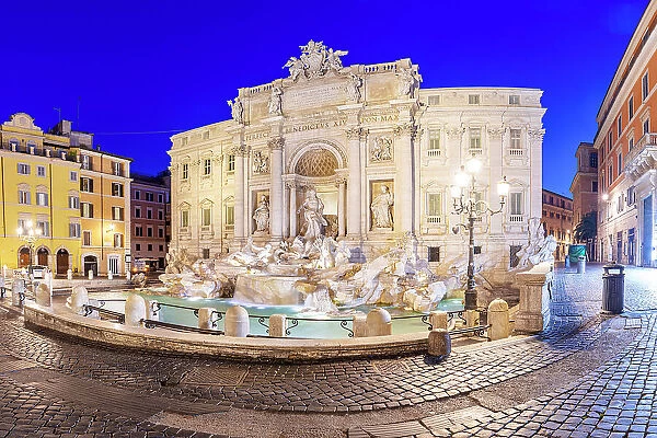 Illuminated Trevi Fountain and buildings at night, Rome, Italy