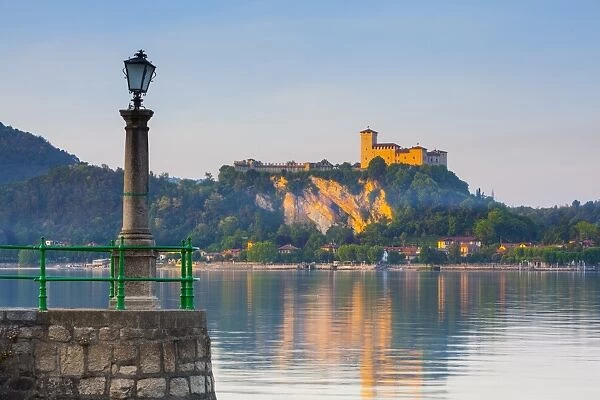 The imposing La Rocca fortress viewd from Arona at sunset, Lake Maggiore, Piedmont, Italy