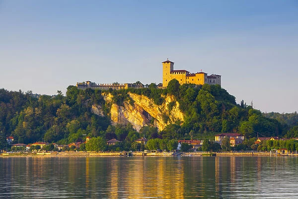 The imposing La Rocca fortress viewd from Arona at sunset, Lake Maggiore, Piedmont, Italy