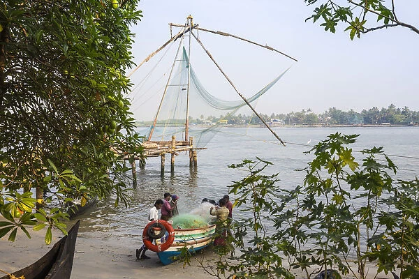 India, Kerala, Cochin - Kochi, Fort Kochi, Fishermen untangle nets wtth Chinese fishing