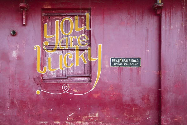 India, Kerala, Cochin - Kochi, Mattancherry, red building with You are lucky painted