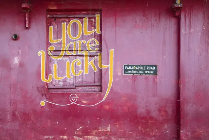 Framed Print : India, Kerala, Cochin - Kochi, Mattancherry, red building with You are lucky painted Framed Print : India, Kerala, Cochin - Kochi, Mattancherry, red building with You are lucky painted