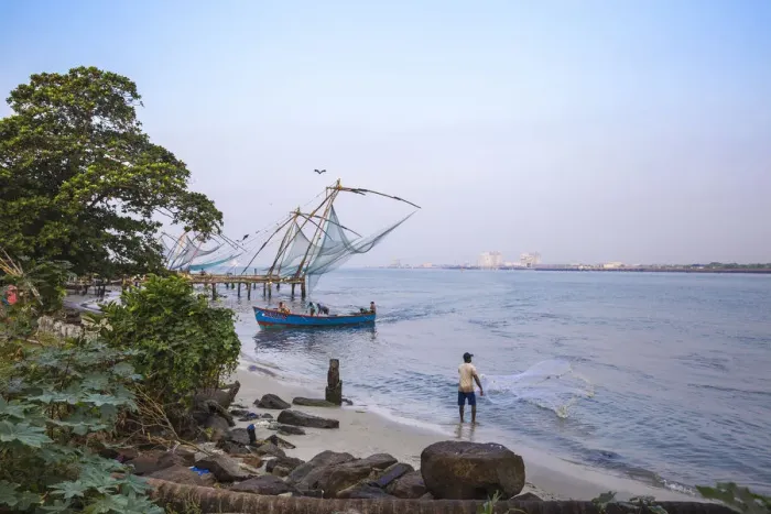 Framed Print : India, Kerala, Cochin - Kochi, Vipin Island, Man fishing infront of Chinese fishing nets