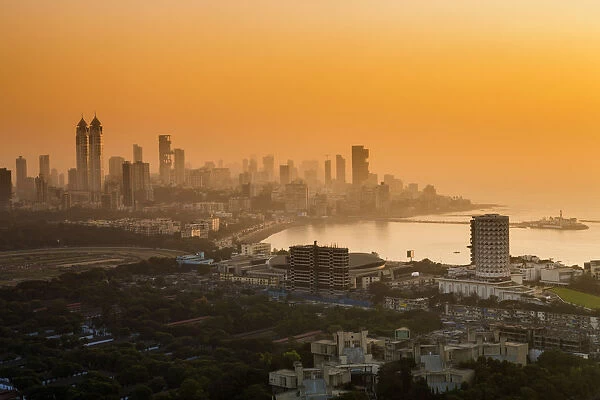 India, Maharashtra, Mumbai, sunset over the city centre and Haji Ali Bay and mosque