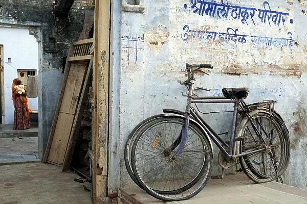 India, Rajasthan, Narlai. Bikes rest outside the doors of a traditional house in the remote village of