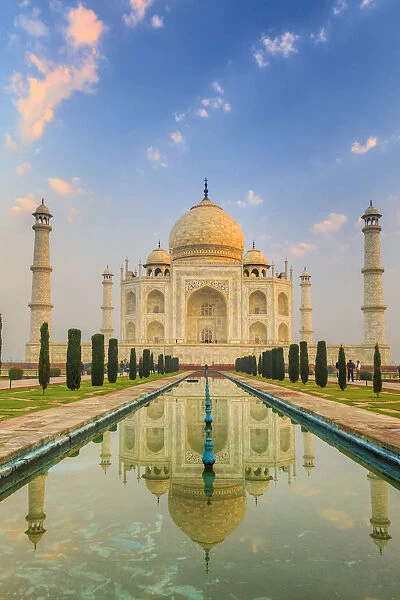 India, Taj Mahal mausoleum in the early morning reflecting in the water pool