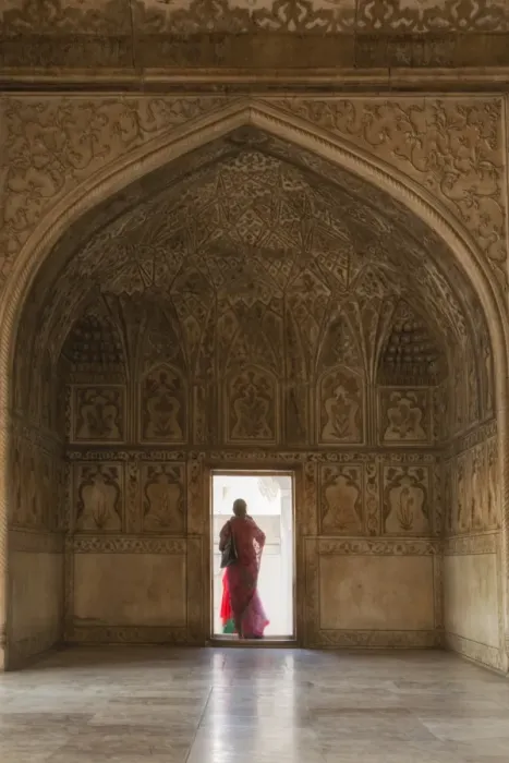 Framed Print : India, Uttar Pradesh, Agra, Agra Fort, a woman in a red saree walks through the interior