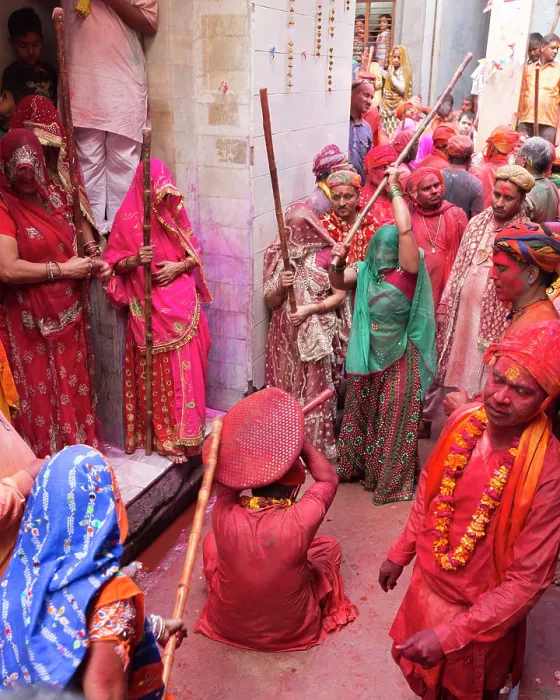 Framed Print : India, Uttar Pradesh, Mathura, Barsana, A man protects himself with a shield from women with sticks during the Lathmar Holi Festival Framed Print : India, Uttar Pradesh, Mathura, Barsana, A man protects himself with a shield from women with sticks during the Lathmar Holi Festival