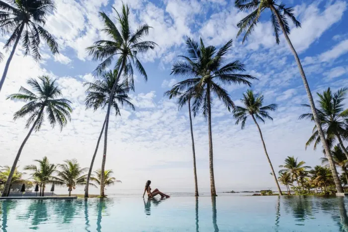 Framed Print : Indonesia, Bali, Candidasa. A young woman sitting on the edge of an infinity swimming Framed Print : Indonesia, Bali, Candidasa. A young woman sitting on the edge of an infinity swimming