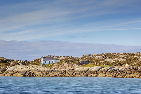 Ireland, Co. Donegal, Arranmore island, House on rocky outcrop