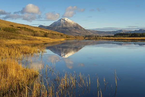 Ireland, Co. Donegal, Snow capped Errigal mountain reflected in Clady river