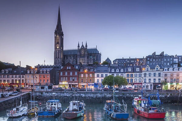Ireland, County Cork, Cobh, St. Colmans Cathedral from Cobh Harbor, dusk