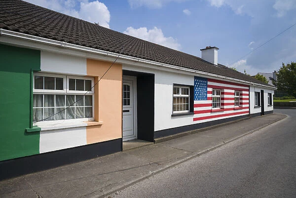 Ireland, County Offaly, Moneygall, house painted with Irish and US flags for visit