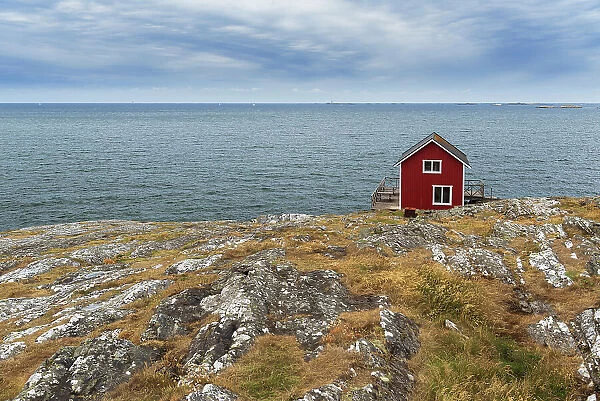Isolated red house overlooking the ocean, Astol, Tjorn municipality, Vastra Gotaland, West Sweden, Sweden