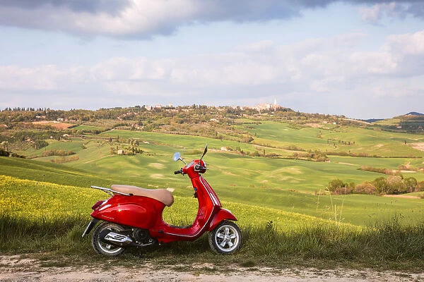 Italian vespa motorcycle in the countryside. Val d Orcia, Tuscany, Italy (PR)