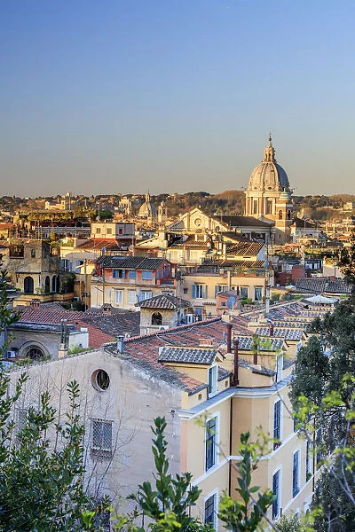 Italy, Rome, Basilica Sant Ambrogio e Carlo church and city roofs at sunrise