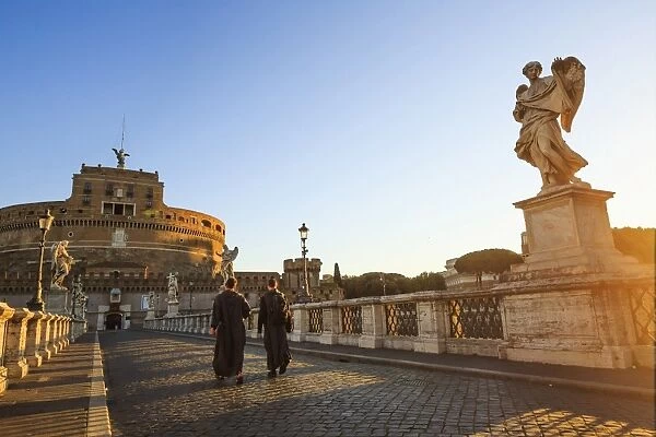 Italy, Rome, two monks walking at Mausoleum of Hadrian (known as Castel Sant Angelo)