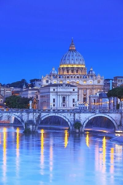 Italy, Rome, St. Peter Basilica by night reflecting on Tevere river