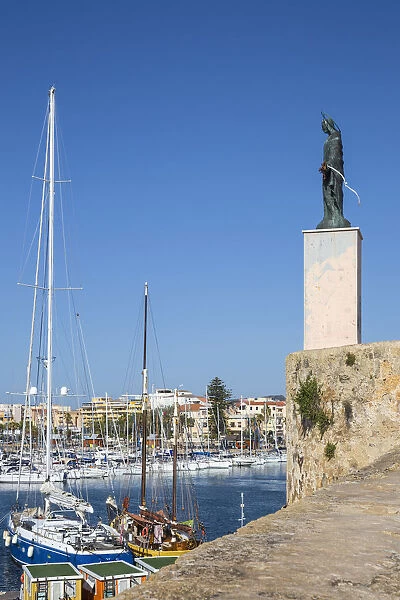 Italy, Sardinia, Alghero, View of harbour and St Elmo statue
