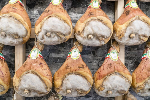 Italy traditional ham (prosciutto) Parma hanging in maturation room