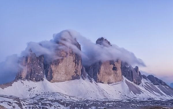 Italy, Trentino-Alto Adige, The Dolomite peaks Tre Cime di Lavaredo wreathed in cloud
