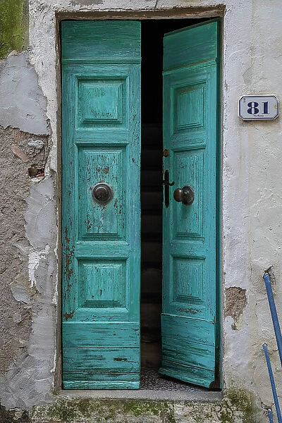 Italy, Tuscany, Elba. An old wooden entrance door to a house in Capoliveri