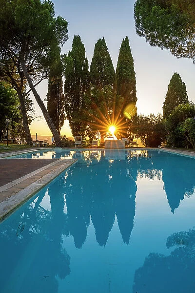 Italy, Tuscany. Sunset at the pool of the Agriturismo Pieve Sprenna near to Buonconvento