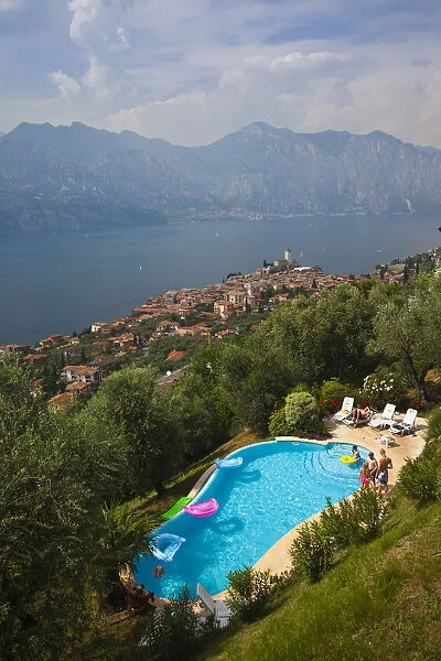 Italy, Veneto, Lake District, Lake Garda, Malcesine, hillside pool and town