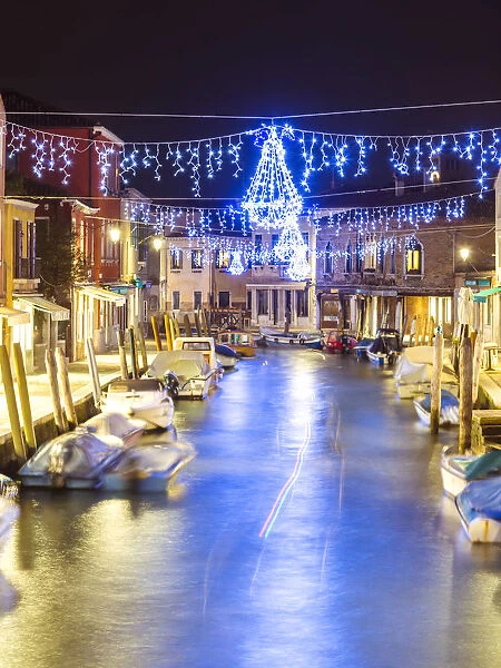 Italy, Veneto, Venice, Murano island. Canal at dusk with Christmas lights hanging
