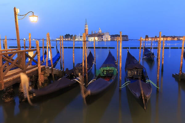 Italy, Veneto, Venice, Sestiere of San Marco, Moored gondolas with San Giorgio Maggiore