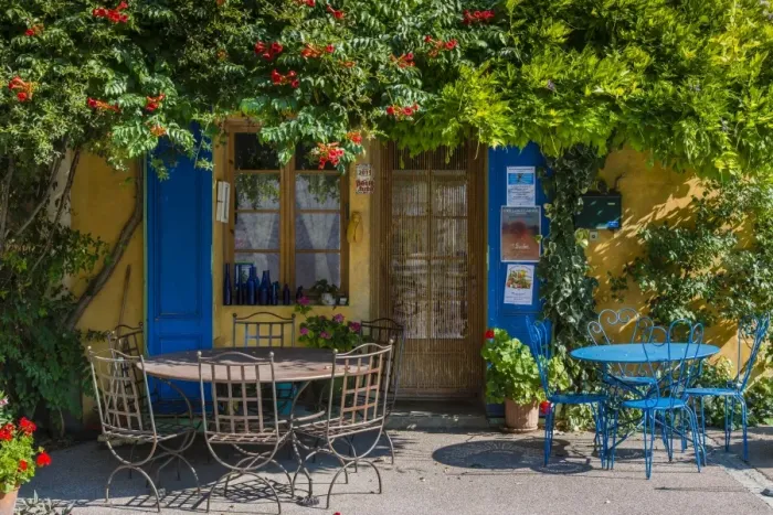 Framed Print : Ivy surrounded house front door with table and chairs in Provence, France Framed Print : Ivy surrounded house front door with table and chairs in Provence, France