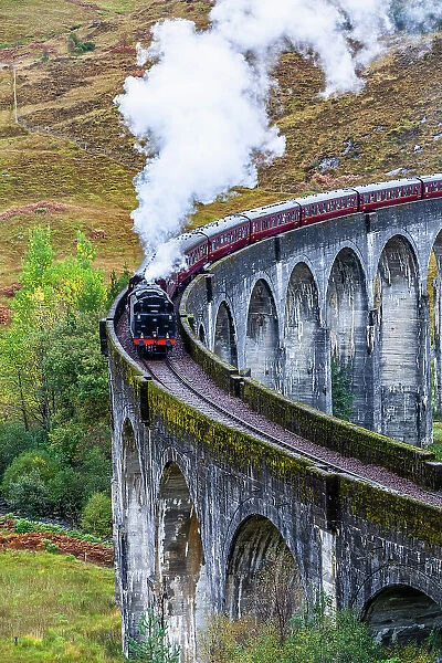 The Jacobite Steam Train, better otherwise known as the Harry Potter Train, crossing the viaduct of Glenfinnan, Glenfinnan, Highland, Scotland, UK