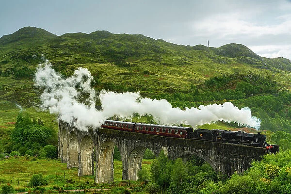 Jacobite steam train crossing Glenfinnan Viaduct, Glenfinnan, Inverness-shire, Scottish Highlands, Scotland, UK