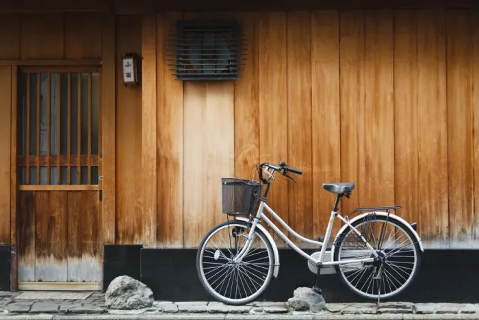 Framed Print : Japan, Chubu Region, Kyoto, Gion. A bicycle rests against the wall of a traditional Framed Print : Japan, Chubu Region, Kyoto, Gion. A bicycle rests against the wall of a traditional